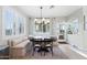 Charming dining nook with banquette seating, shuttered windows, and an elegant chandelier at 28408 N 52Nd Way, Cave Creek, AZ 85331