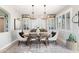 Elegant dining room featuring a rustic table, chandelier, and ample natural light at 28408 N 52Nd Way, Cave Creek, AZ 85331