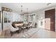 Elegant dining room with wood table, upholstered chairs, and natural light through plantation shutters at 28408 N 52Nd Way, Cave Creek, AZ 85331