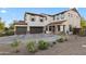 Two-story home showcasing a three-car garage, desert landscaping, shutters, and a welcoming front porch at 28408 N 52Nd Way, Cave Creek, AZ 85331