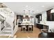 Bright, open kitchen with island, stainless steel appliances, and dining area near a staircase at 28408 N 52Nd Way, Cave Creek, AZ 85331
