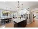 Open eat-in kitchen with a center island, decorative lighting, and stainless appliances at 28408 N 52Nd Way, Cave Creek, AZ 85331