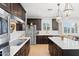 Modern kitchen with dark cabinetry, stainless steel appliances, and bright white countertops at 28408 N 52Nd Way, Cave Creek, AZ 85331