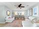 Cozy living room features neutral decor, a ceiling fan, and natural light at 28408 N 52Nd Way, Cave Creek, AZ 85331