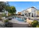 Resort-style pool area with a fire pit, mature trees, and outdoor seating for luxurious relaxation at 28408 N 52Nd Way, Cave Creek, AZ 85331