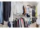 This walk-in closet is organized with custom shelving and hanging rods for ample storage at 3105 E Amber Ridge Way, Phoenix, AZ 85048