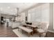 Open-concept dining area with elegant furnishings, shuttered windows, and views of the modern kitchen at 3105 E Amber Ridge Way, Phoenix, AZ 85048
