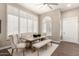Bright dining area featuring shuttered windows, stylish seating, and contemporary lighting fixtures at 3105 E Amber Ridge Way, Phoenix, AZ 85048