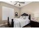 Cozy guest bedroom with a queen bed, floral pillows, and a black dresser at 3105 E Amber Ridge Way, Phoenix, AZ 85048