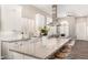 Modern kitchen offers a spacious island, stainless steel appliances, and bright lighting, perfect for culinary enthusiasts at 3105 E Amber Ridge Way, Phoenix, AZ 85048