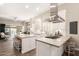 Bright kitchen with stainless appliances, kitchen island, and seamless flow into the living space is ideal for entertaining at 3105 E Amber Ridge Way, Phoenix, AZ 85048