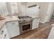 Close-up of kitchen island featuring a high-end stainless steel gas range and oven, a chef's dream at 3105 E Amber Ridge Way, Phoenix, AZ 85048