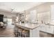 Bright, open kitchen with a large island and seating transitions seamlessly into a comfortable living area at 3105 E Amber Ridge Way, Phoenix, AZ 85048