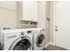 Convenient laundry room with modern washer and dryer units and built-in storage at 3105 E Amber Ridge Way, Phoenix, AZ 85048