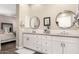 This bathroom features a double sink vanity, white cabinets and tile, and neutral paint at 3105 E Amber Ridge Way, Phoenix, AZ 85048