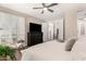 Relaxing main bedroom boasts a comfortable sitting area, television, and natural light at 3105 E Amber Ridge Way, Phoenix, AZ 85048