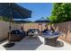 Inviting outdoor patio with comfortable seating arrangements and shade umbrellas at 3105 E Amber Ridge Way, Phoenix, AZ 85048