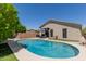Stunning backyard pool with desert landscaping and relaxing patio area at 3105 E Amber Ridge Way, Phoenix, AZ 85048