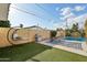 Outdoor retreat with artificial grass, patio, and barbecue setup, perfect for enjoying sunny days and entertaining guests at 3202 N 21St St, Phoenix, AZ 85016