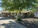 Charming single-story home with mature tree in front yard and seating at 3202 N 21St St, Phoenix, AZ 85016
