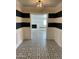 Hallway with striking black and white striped accent wall and patterned tile flooring at 3202 N 21St St, Phoenix, AZ 85016