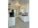 Bright kitchen featuring white cabinetry, black countertops, and black and white flooring at 3202 N 21St St, Phoenix, AZ 85016