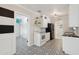 Bright kitchen features white cabinets, black appliances and countertops, and decorative tile flooring at 3202 N 21St St, Phoenix, AZ 85016