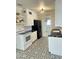 Kitchen features white cabinets, black appliances, and striking patterned tile floor at 3202 N 21St St, Phoenix, AZ 85016