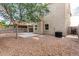 Spacious backyard with rock landscaping, a concrete patio, and a stucco two-story house at 337 N 103Rd Pl, Apache Junction, AZ 85120