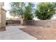 Fully fenced backyard with desert landscaping and a concrete patio at 337 N 103Rd Pl, Apache Junction, AZ 85120