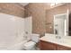 A bathroom featuring a vanity, a toilet, and a white-tiled shower-tub combo at 337 N 103Rd Pl, Apache Junction, AZ 85120