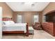 A bedroom features natural light, carpet, and a wood-framed bed at 337 N 103Rd Pl, Apache Junction, AZ 85120