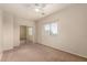 Bright bedroom with neutral walls, carpet, a ceiling fan, and a sliding-door closet at 337 N 103Rd Pl, Apache Junction, AZ 85120
