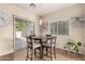 Bright dining area with large window, sliding glass door, and pendant light at 337 N 103Rd Pl, Apache Junction, AZ 85120