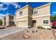 Tan, two-story home with desert landscaping, two car garage and tile roof at 337 N 103Rd Pl, Apache Junction, AZ 85120