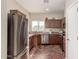 The kitchen features stainless steel appliances and beautiful brick flooring at 337 N 103Rd Pl, Apache Junction, AZ 85120