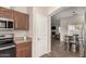 An updated kitchen features stainless appliances, wood cabinetry, and opens up to the dining area and living room at 337 N 103Rd Pl, Apache Junction, AZ 85120
