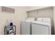 Laundry room equipped with a washer, a dryer, and a storage shelf at 337 N 103Rd Pl, Apache Junction, AZ 85120