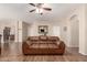 Open-concept living room with wood floors, ceiling fan, and tan walls at 337 N 103Rd Pl, Apache Junction, AZ 85120