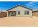 View of the back of the house with patio and large dirt backyard with potential for landscaping at 343 S 202Nd Dr, Buckeye, AZ 85326