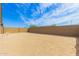 Spacious dirt backyard enclosed by a tall brick wall, offering privacy and potential for landscaping at 343 S 202Nd Dr, Buckeye, AZ 85326