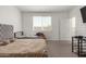 Neutral bedroom features carpet, an upholstered headboard and a view of the five-panel door at 343 S 202Nd Dr, Buckeye, AZ 85326