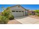 Charming single-story home features a two-car garage, neutral stucco, stone accents and low-maintenance desert landscaping at 343 S 202Nd Dr, Buckeye, AZ 85326