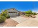 Charming single-story home features a two-car garage, neutral stucco, stone accents and low-maintenance desert landscaping at 343 S 202Nd Dr, Buckeye, AZ 85326