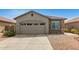 Charming single-story home features a two-car garage, neutral stucco, stone accents and low-maintenance desert landscaping at 343 S 202Nd Dr, Buckeye, AZ 85326
