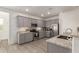 Cozy kitchen showcases stainless steel appliances, light granite countertops and grey cabinets at 343 S 202Nd Dr, Buckeye, AZ 85326