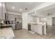 Bright kitchen with stainless appliances, granite countertops and gray cabinets next to the open-concept living area at 343 S 202Nd Dr, Buckeye, AZ 85326
