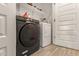 Modern laundry room features a new black Samsung washing machine and bright white dryer, with convenient shelving at 343 S 202Nd Dr, Buckeye, AZ 85326