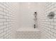 Stylish walk-in shower with white subway tile, corner seat and built-in shelving at 343 S 202Nd Dr, Buckeye, AZ 85326