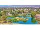 Scenic aerial view of a golf course community with tranquil lakes, lush fairways, and beautiful homes at 3800 S Cantabria Cir # 1077, Chandler, AZ 85248